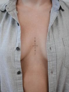 a man with a cross tattoo on his chest