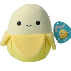 a stuffed animal with a tag on it's chest and an egg in the background