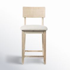 a wooden stool with a white upholstered seat and back rest on an isolated background