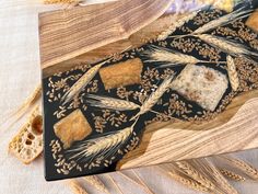 an artistically designed cutting board with wheat on it