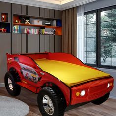 a child's bed with a yellow and red cover on it