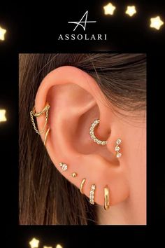 an ear with three different types of piercings on it and the words assolari written