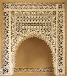 an arch in the middle of a wall with carvings on it's sides and arches