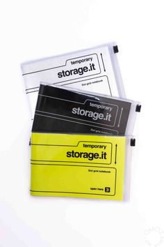 three storage it folders sitting next to each other on top of a white surface