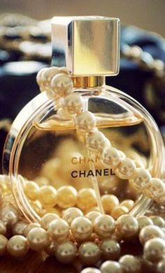 chanel perfume bottle with pearls around it