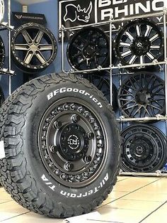 tires and wheels are on display in a showroom