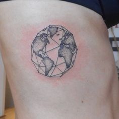 a woman's stomach with a small world map tattoo on the back of her thigh