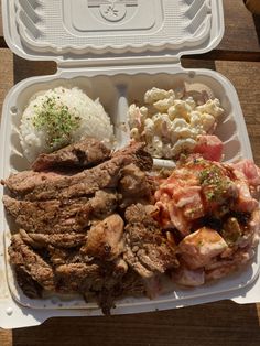 a plastic container filled with meat and rice