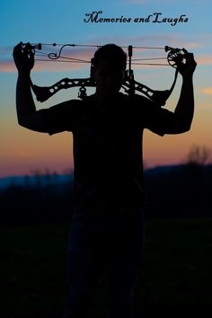 a man with headphones on his ears is holding up wires in front of the sun