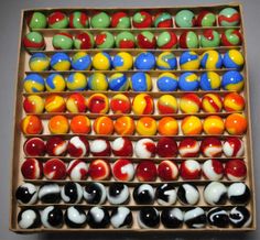 a box filled with lots of different colored candies on top of a table next to each other