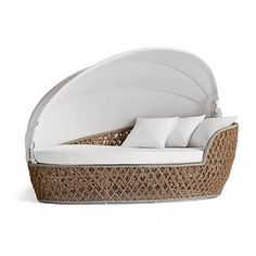 the bed is made with wicker and white sheets