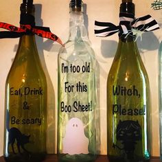 three empty bottles with halloween sayings on them