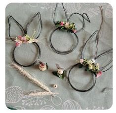 four pieces of hair with flowers and leaves on them sitting on top of a table