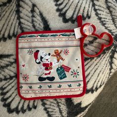 a mickey mouse pot holder on a blanket