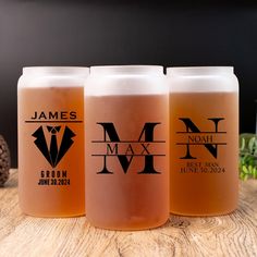 three beer glasses sitting on top of a wooden table