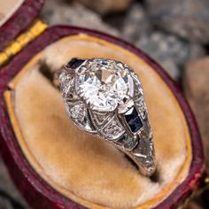 an antique diamond and sapphire ring in a velvet box