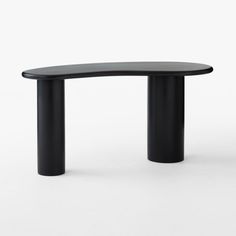 an oval table with black legs and a curved top, on a white background in front of the camera