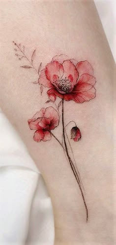 a woman's thigh with red flowers on it