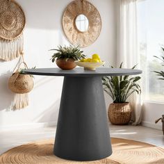 a round table in the middle of a room with potted plants and baskets hanging on the wall