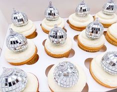 cupcakes with silver disco ball decorations on top