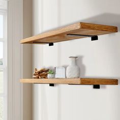 two wooden shelves in front of a window