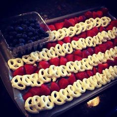 an american flag dessert with strawberries and blueberries in the shape of pretzels