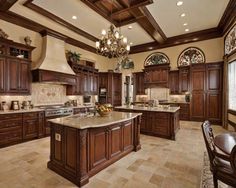 a large kitchen with wooden cabinets and marble counter tops, along with a center island