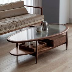 a living room with a couch, coffee table and two end tables in front of a window