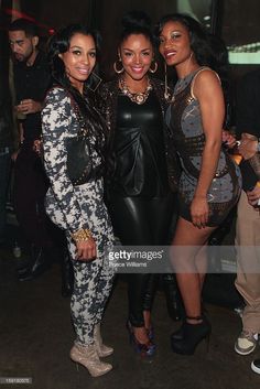 three women posing for the camera at an event