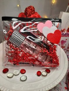 a clear bag filled with valentine's items on top of a table