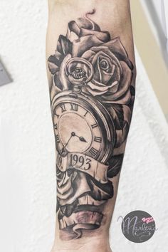 a black and white tattoo on the arm of a person with a clock in front of them