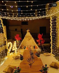 a long table is decorated with lights and decorations