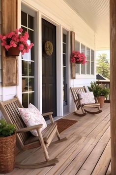 two rocking chairs sitting on the front porch