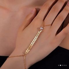 This Beautiful Hand Chain Ring Bracelet Is Perfect For Any Fashion-Forward Woman. The Dainty Pearl Leaf Design Adds A Touch Of Elegance To Any Outfit, While The Gold Color Gives It A Luxurious Feel. The Bracelet Is Crafted From High-Quality Materials, Ensuring It Will Last For Years To Come. The Ring Bracelet Is Designed To Fit Comfortably On Any Finger, Making It A Versatile Accessory That Can Be Worn With Any Outfit. The Shape Of The Leaf Is A Gorgeous Addition To The Piece, Adding A Touch Of Chain Ring Bracelet, Finger Ring Bracelet, Ring Bracelet Chain, Hand Chain, Finger Ring, Bracelet For Women, Bracelet Gold, Ring Finger, Chain Ring