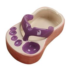 a purple and white ceramic shoe shaped dish