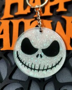 a close up of a keychain with a face on it and the words happy halloween