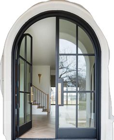 an arched glass door leading into a hallway