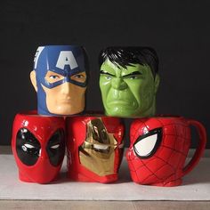 the avengers mugs are stacked on top of each other with faces painted on them