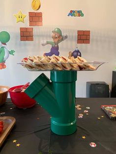 a table topped with lots of food on top of a black tablecloth covered table