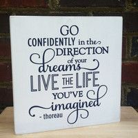 a sign that says go confidently in the direction of your dreams live the life you've