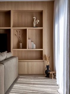 a living room filled with furniture and bookshelves