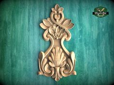 an intricately carved wooden design on a green background