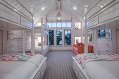 bunk beds are lined up in the middle of a room with windows and carpeted flooring