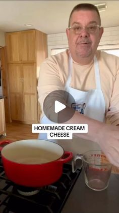 a man in an apron is making homemade cream cheese soup on the stove with his hands