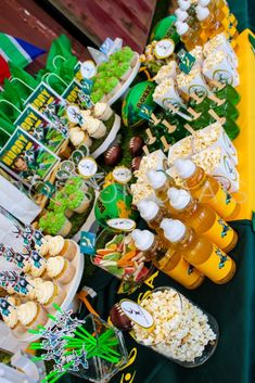 a football themed dessert table with drinks and snacks