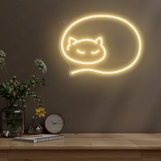 a neon sign with a cat's head in the shape of a speech bubble