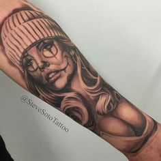 a woman's arm with a tattoo on it that has an image of a woman wearing a hat