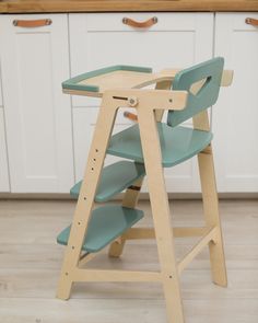 a child's wooden high chair in the kitchen