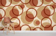 a chair sitting in front of a wall with circles on it