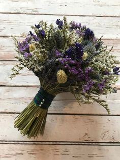 a bouquet of flowers sitting on top of a wooden table